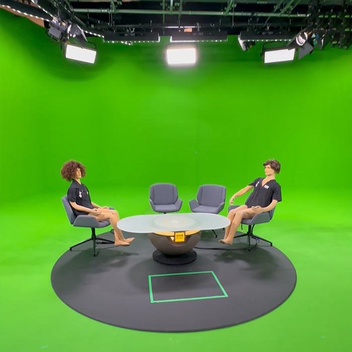 Here we see the entirety of the real, physical elements in the BBC greenscreen studio. The desk, mat and chairs are real - the presenters are also real, but in testing we use the poseable foam mennequins seen here. Everything else is greenscreen, and will be replaced by the virtual set.